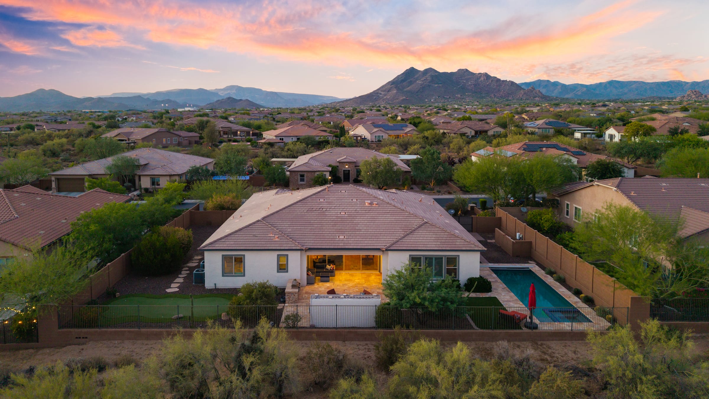 Homes below a desert peak at sunset, Carefree