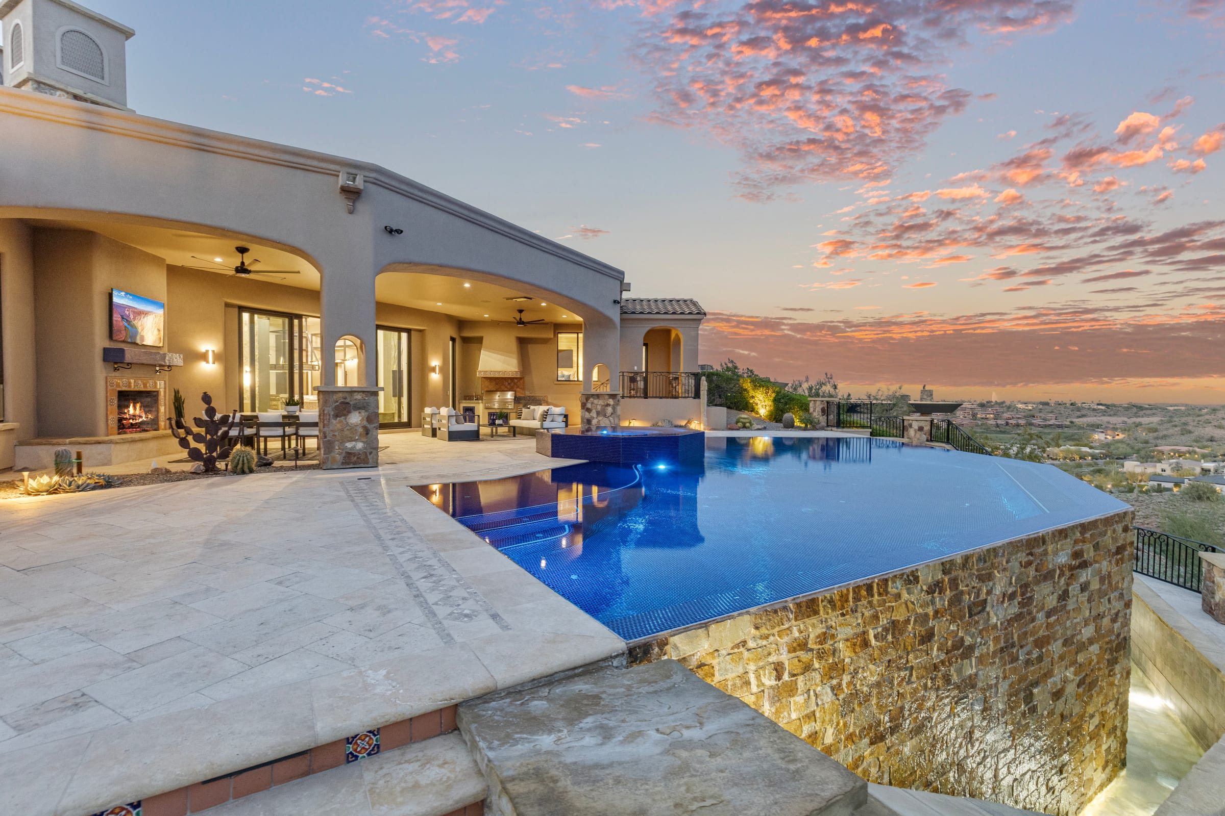Desert residence and pool terrace at last light, mountains beyond