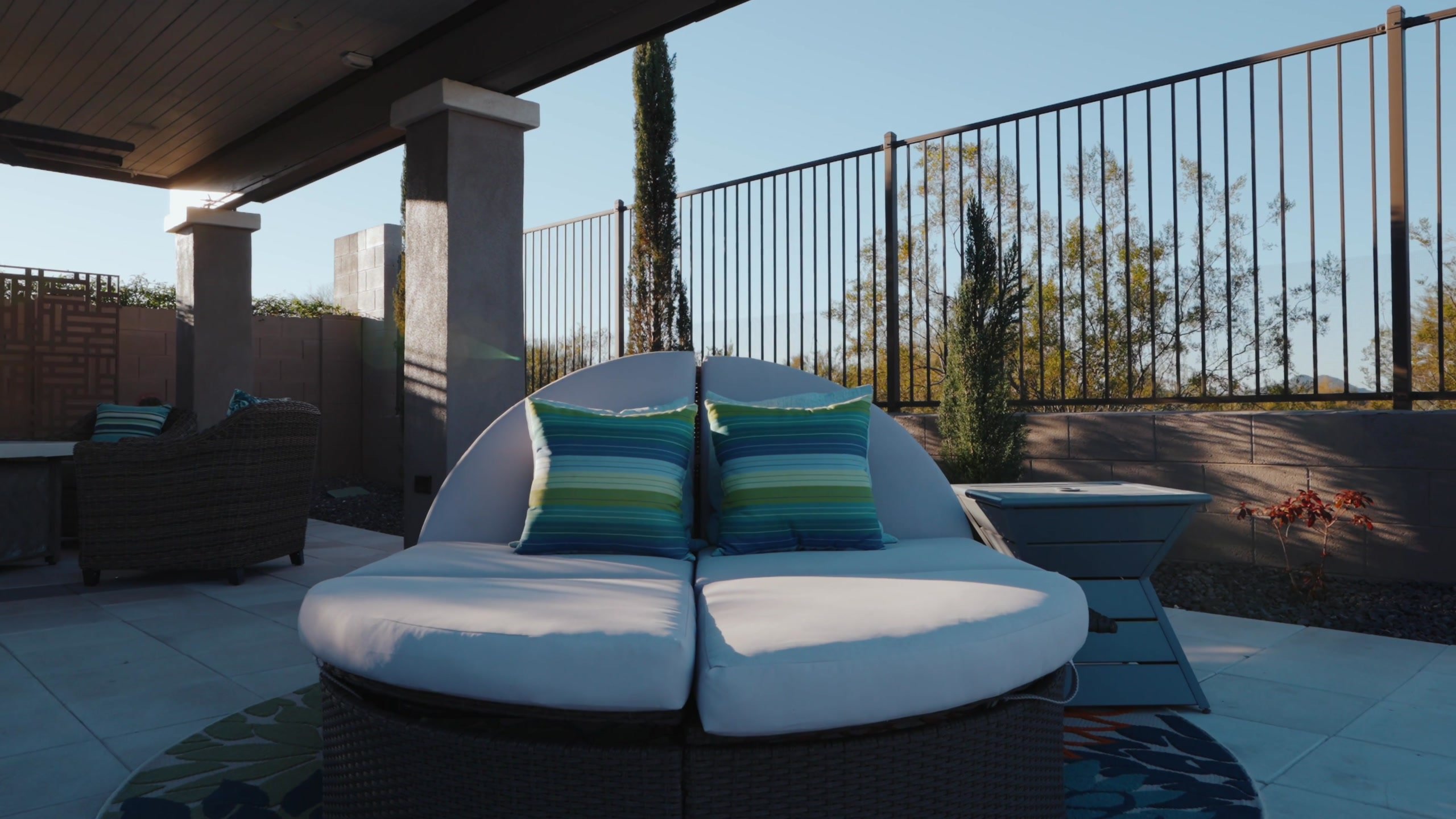 A private desert estate pool and covered patio at dusk